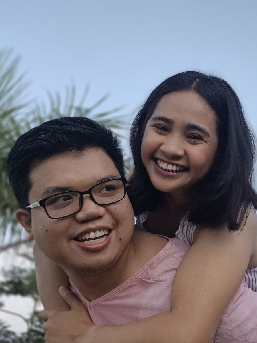 Geselle riding piggyback on Roi, both laughing